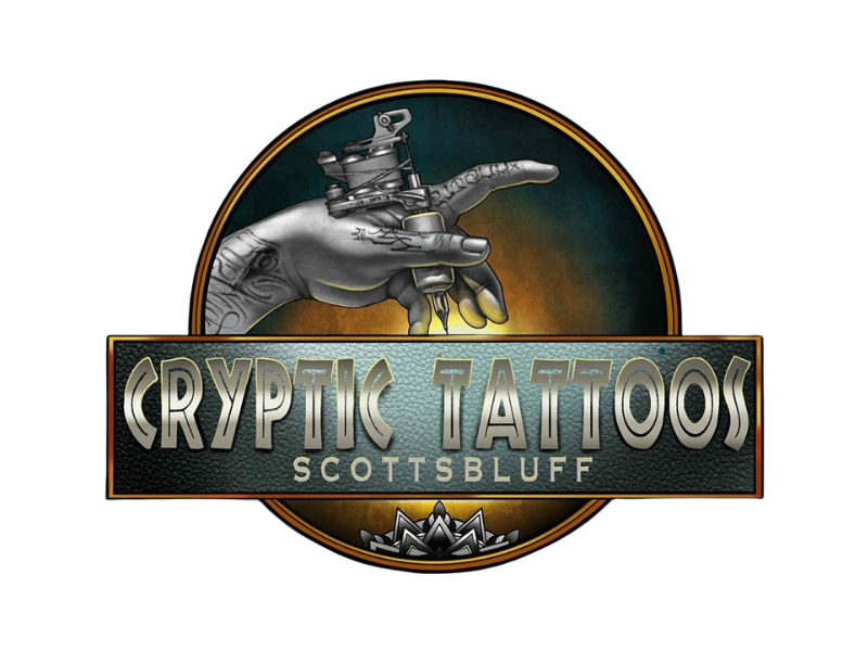 Logo for Cryptic Tattoos featuring a hand holding a tattoo machine, set against a circular background with the text 'Cryptic Tattoos Scottsbluff'.